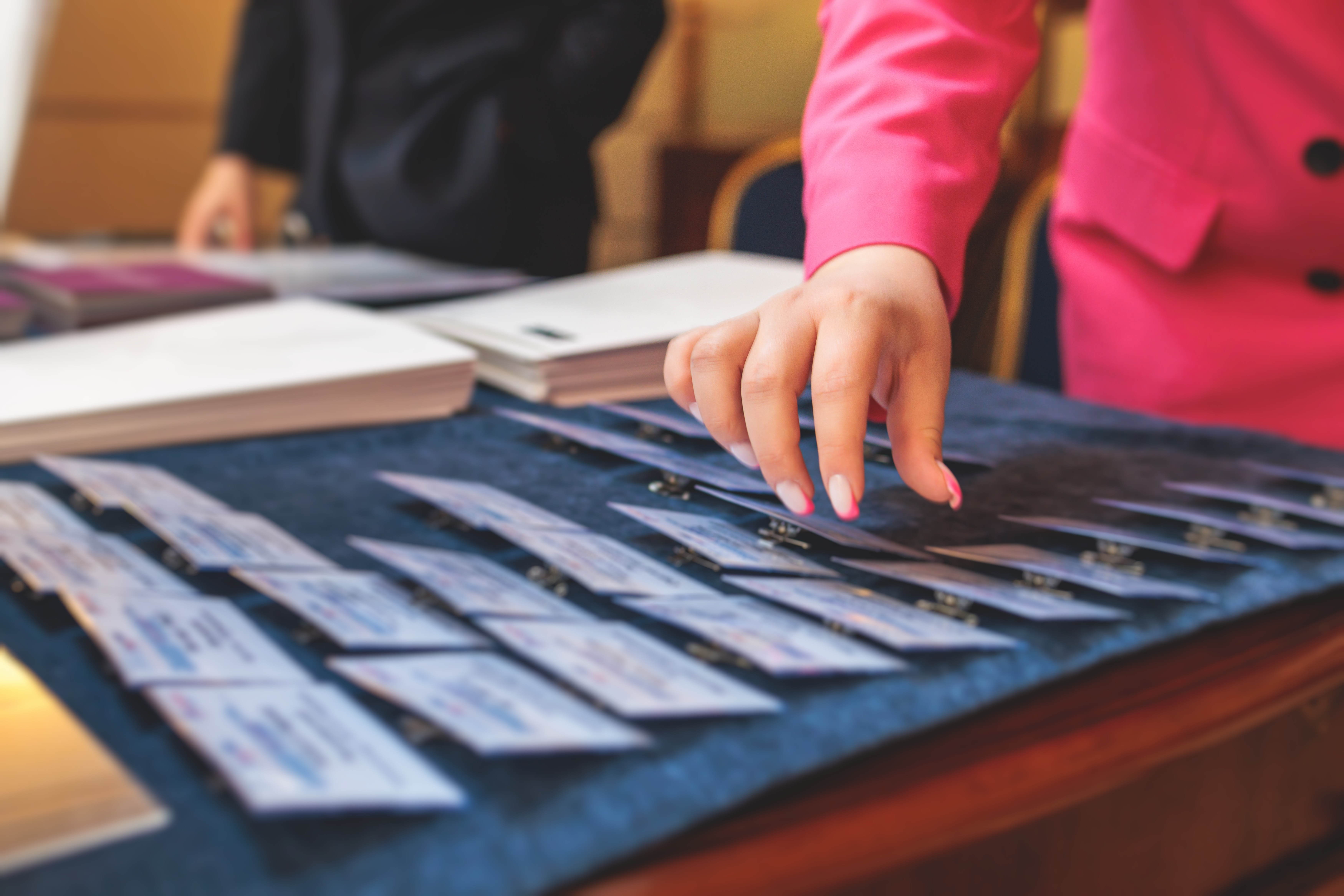 A registration desk staffed by two people for the CMAA 2022 event