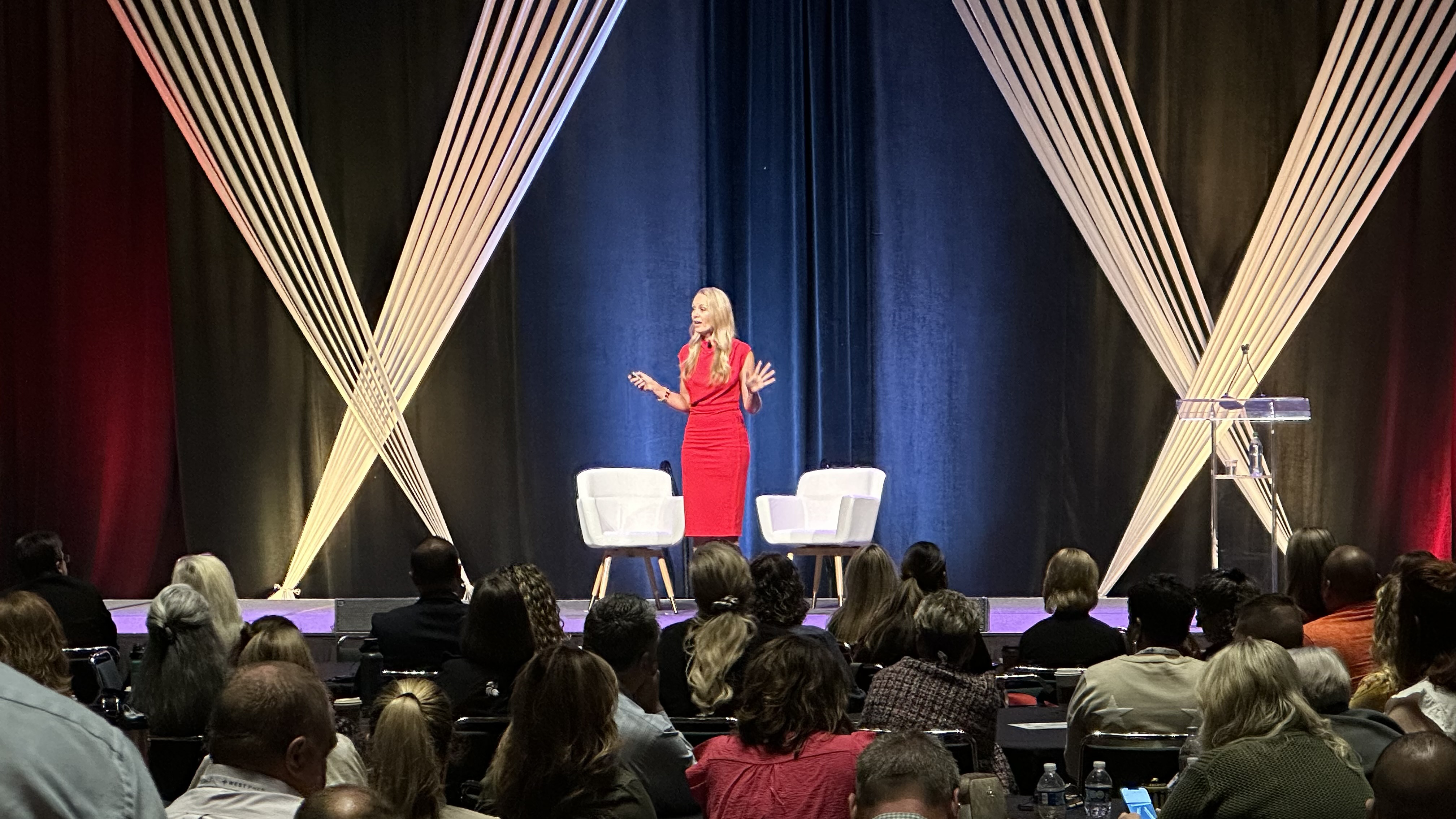 A speaker delivering a presentation on stage